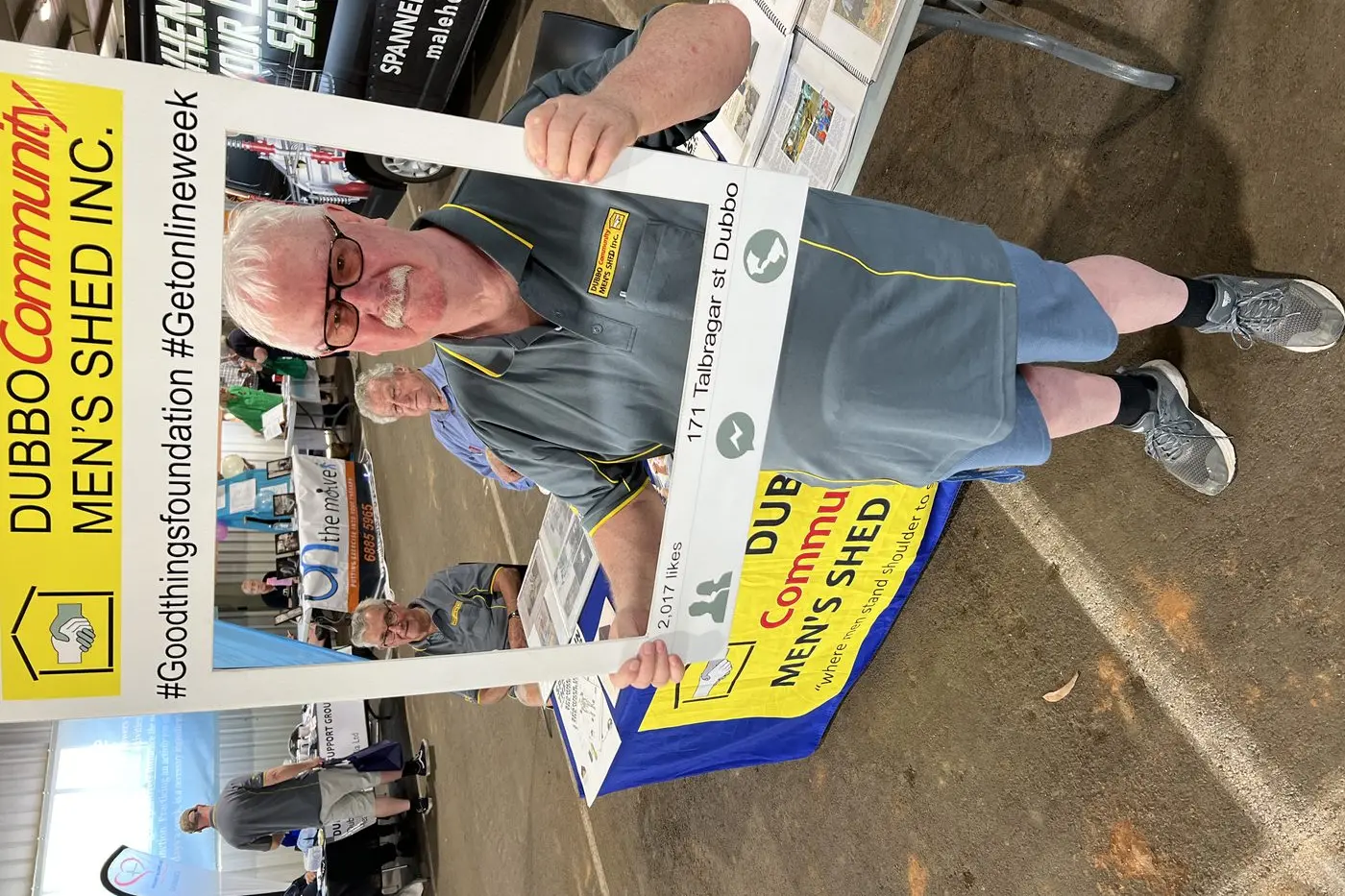 Dubbo Community Men\\u2019s Shed secretary John Gibson (holding the sign) and fellow shed members spent the day at the recent Living Well Expo talking to local residents about health and wellbeing. Photo: Dubbo Photo News