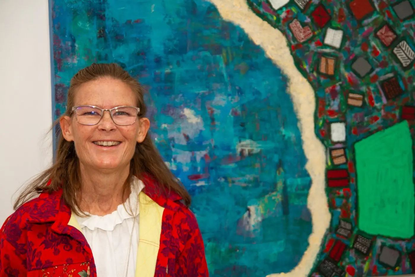 Kate Kenworthy alongside one of her vibrant painting at Western Plains Cultural Centre. Kate\\'s HomeGround exhibition is open until July 31. Photo: Dubbo Photo News