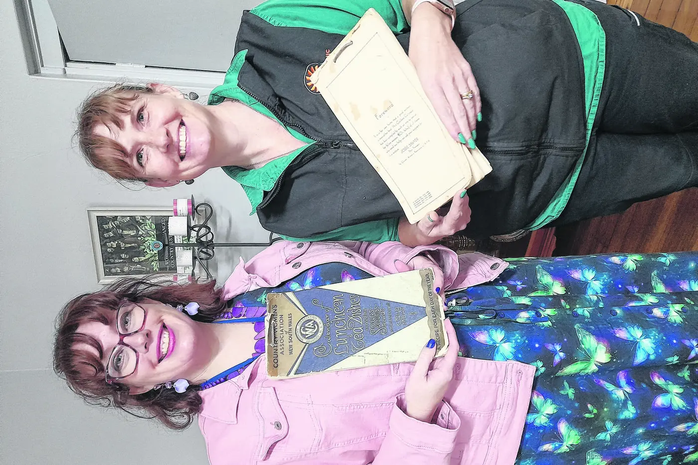 Antique of an earlier time: Gilgandra CWA members Jess and Rebekah with the wonderful 1930s cookbooks recently donated by Mrs Pat Foran. Photo: Supplied.
