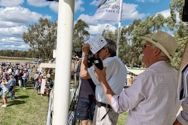 Veteran racecaller Col Hodges calling a race at the Tomingley Picnic Races, April 2022. Photo: Dubbo Photo News.