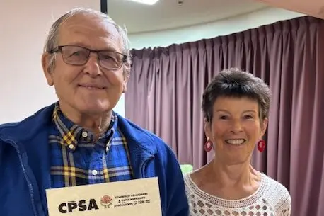 Garry Gowans being presented with a special certificate by CPSA branch member Naomi Geck. Photo: Supplied.