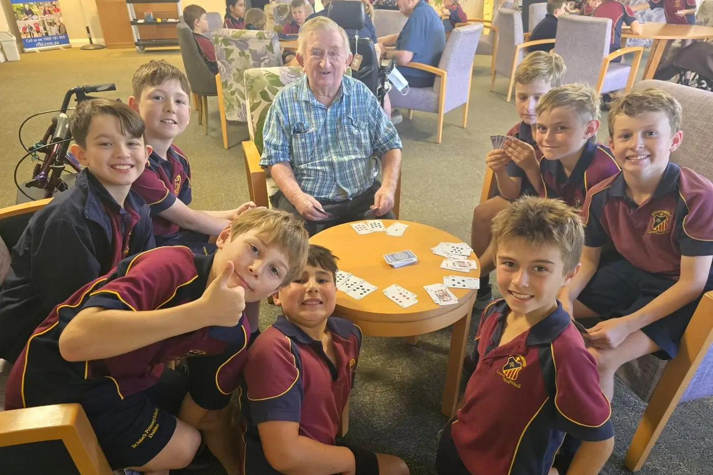Never too young, or old, to learn cards! Dubbo St Johns pupils at Dubbo Masonic Village as part of an initiative with local schools, aimed at enriching the lives of both its residents and the young. Photo: Supplied