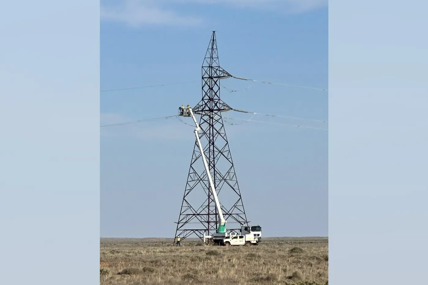 Workers repair storm-damaged electricity pylons after power was cut to Broken Hill and surrounds. Photo: AAP/TRANSGRID