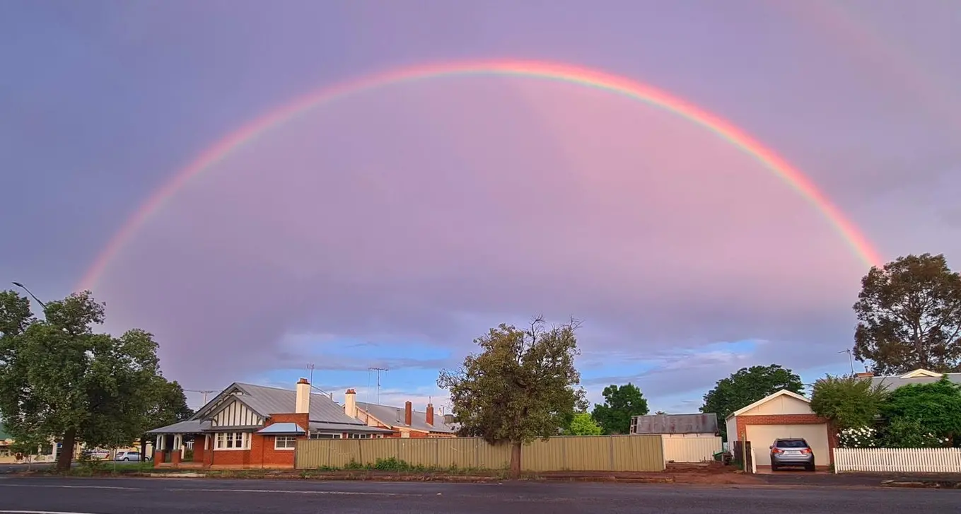 A rainbow dividing the purple sky