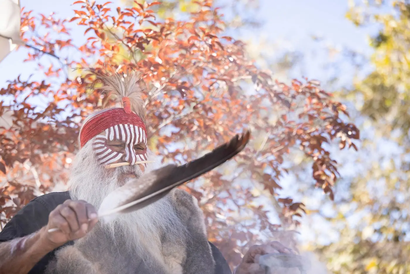 Ngarrindjeri elder Major Sumner conducted a smoking ceremony to mark the repatriation of remains. Photo: AAP/Department of Infrastructure, Transport, Regional Development, Communications and The Arts