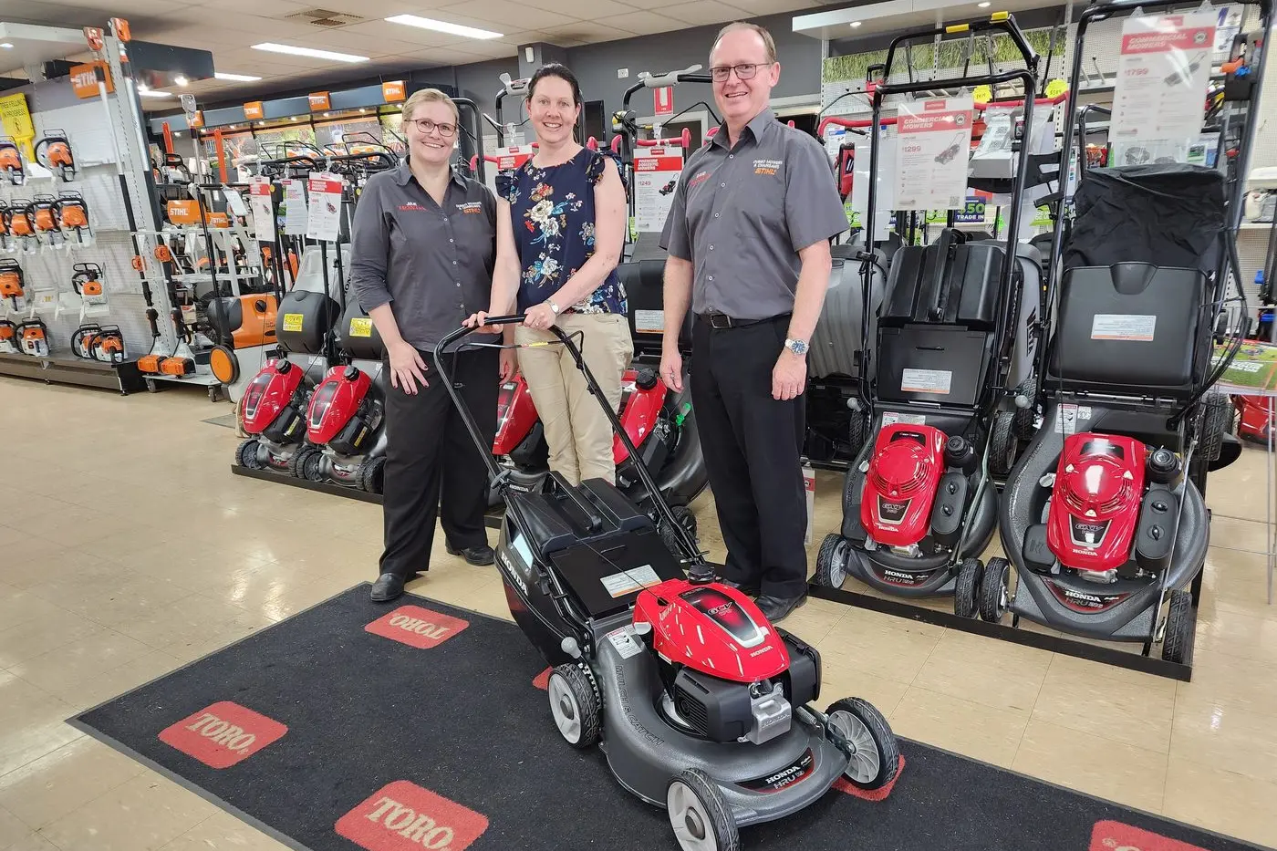 Competition winner Belinda Bourke was delighted to be presented her new mower by Dubbo Mowers and Chainsaws\\' Julie and David Brett. Photo: Dubbo Photo News