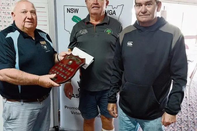 NSWVGA Vice-President, John Dixon presents Rob Williams and Tony Mann the 4b Winners trophy for the Sand Green Fourball Championships at Narromine. Photos: Supplied