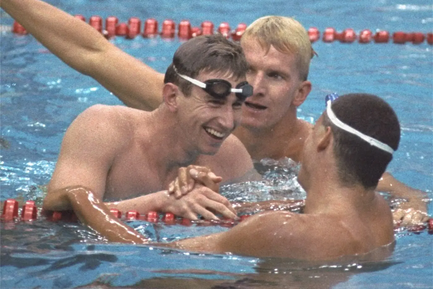 Duncan Armstrong of Australia, left, is congratulated by Matt Biondi, after Armstrong\\'s victory and new world record time in the Olympic men\\'s 200-metre freestyle at the 1988 Seoul Olympic Games. In the background is West German start Michael Gross who finished fifth. Photo: AP Photo/Lennox McLendon.