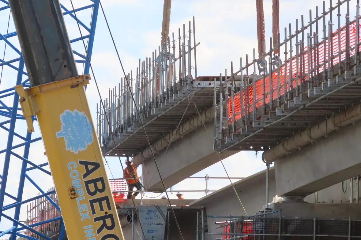 The final girder in edged into place, under the guidance of workers at the New Dubbo Bridge site. Photo: Dubbo Photo News/Ken Smith