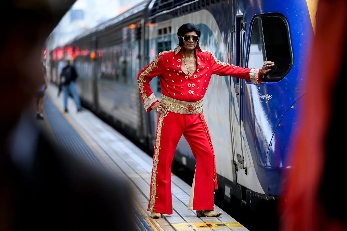 Fan Alfred Vaz poses for a photograph dressed up as Elvis Presley as he waits for the departure of the Elvis Express bound for Parkes, at Central Station in Sydney on Thursday, January 9. Hundreds of passengers hopped on the train to Parkes for the 2025 Parkes Elvis Festival. Photo: AAP/Bianca De Marchi