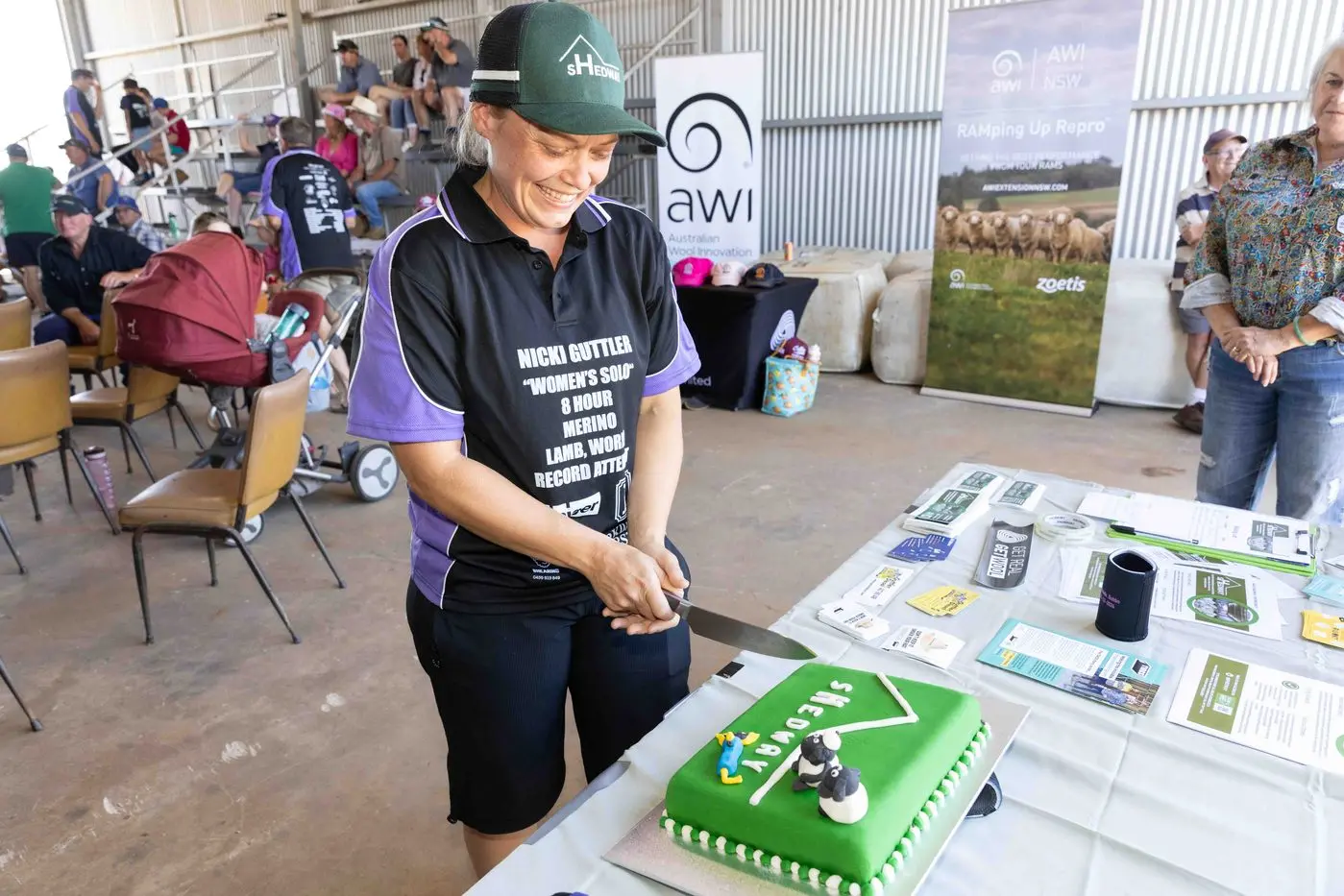 Carol Mudford cuts a cake to celebrate one year of sHedway during Nick Guttler\\u2019s successful world record attempt at Parkdale SRS Merino Stud. Photo: Courtesy Noni Carroll.