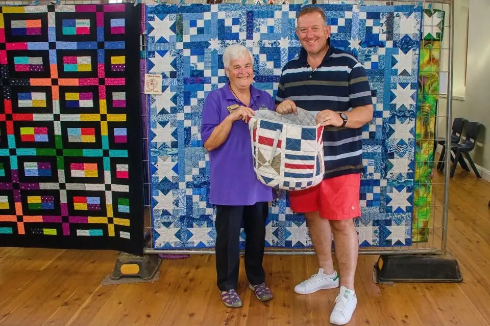 The raffle draw conducted by Rod Crowfoot, right, of Dubbo Macquarie Homestay. Photo: Supplied.