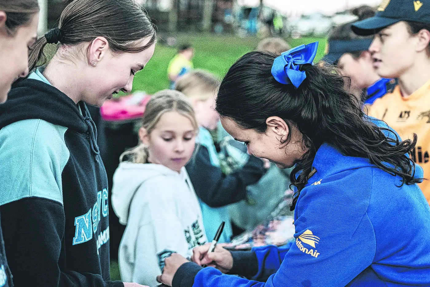 Parramatta NRLW (NRL Women\\'s Premiership) star Taneka Todhunter signing autographs for fans. Photo: Parramatta Eels RLFC.