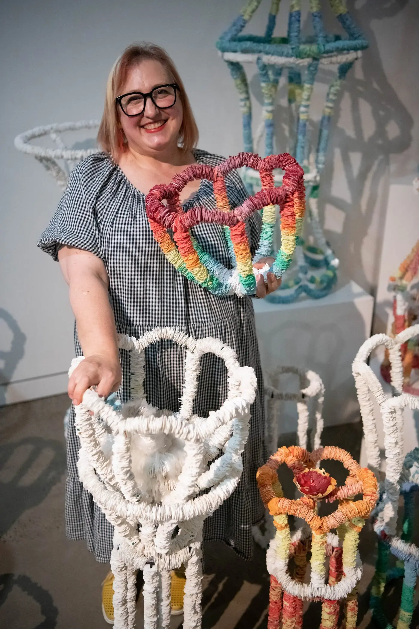 A Lot of Little Nothings: Artist Shani Nottingham with some of her works created from bread tags, on display now at the Western Plains Cultural Centre in Dubbo. Photo: Supplied.
