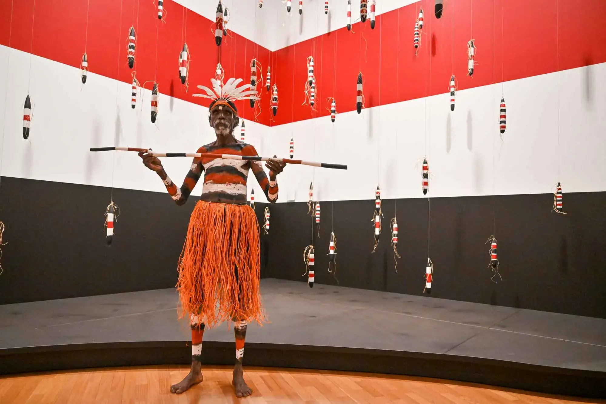 <p>An indigenous dancer poses in front of an installation as part of the 5th National Indigenous Art Triennial:\\u202FAfter the Rain at the National Gallery of Australia in Canberra on Thursday, December 4. Photo: AAP Image/Mick Tsikas</p>\\n