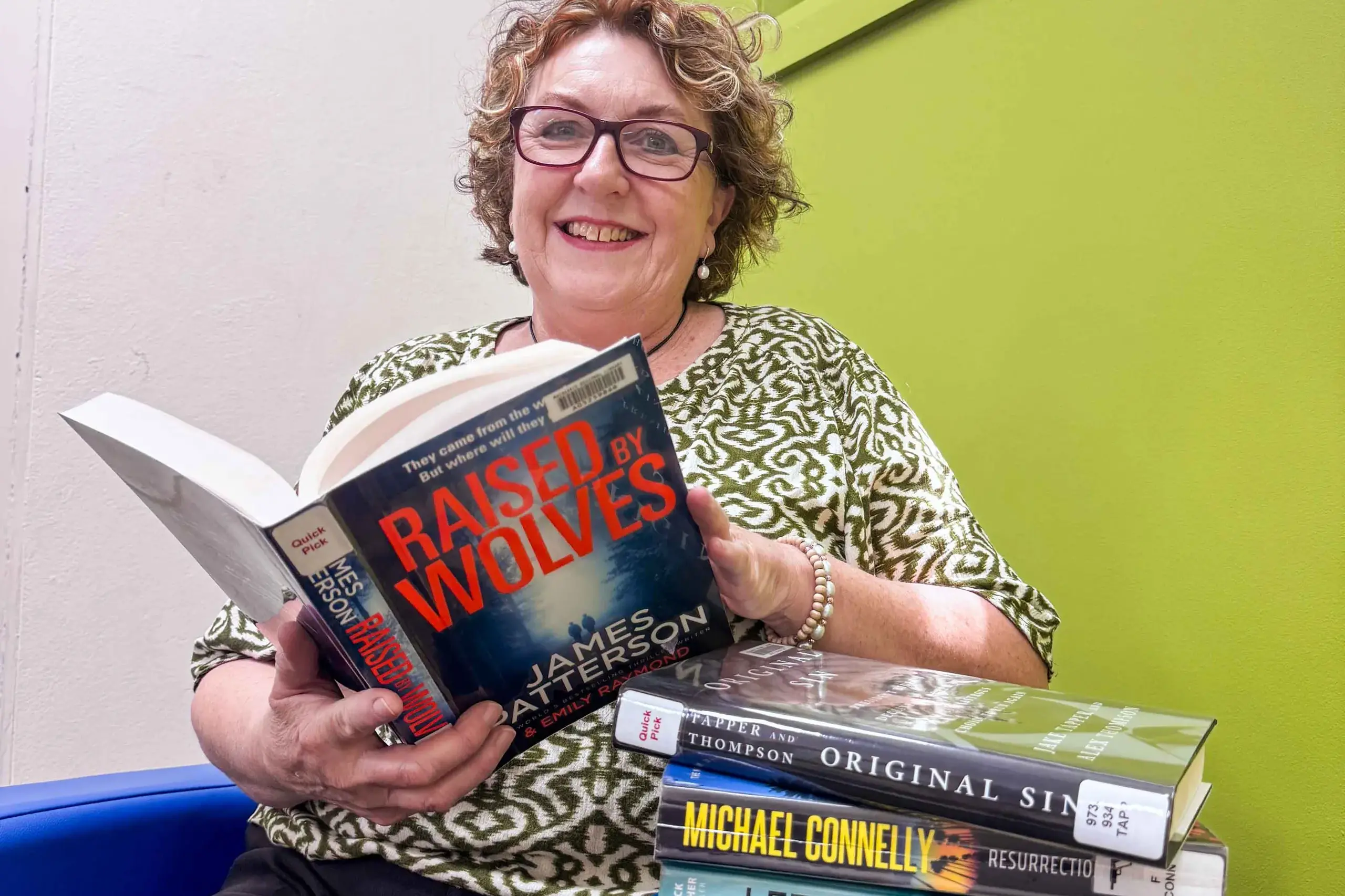<p> IMAGE: Librarian Margot Drake from the Wellington Library with some of the 2025 top borrowed books. Photo: Supplied. </p>\\n