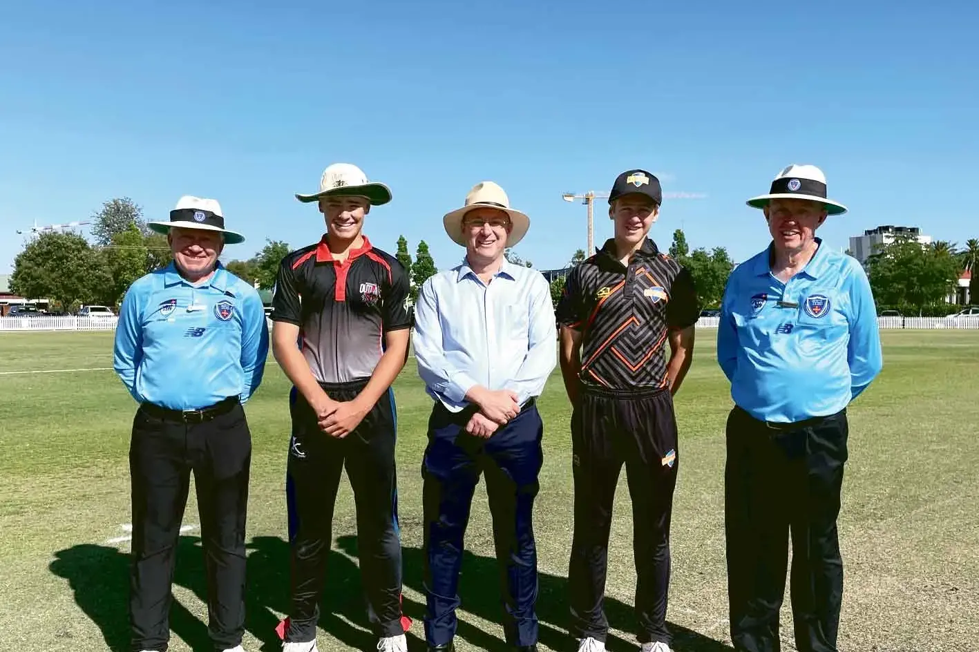 <p>Dubbo Regional Council Mayor Josh Black (centre) with Western Plains captain Eli Heffernan and Murray captain Harry Bowles with the game\\u2019s umpire. Photo: DRC</p>\\n