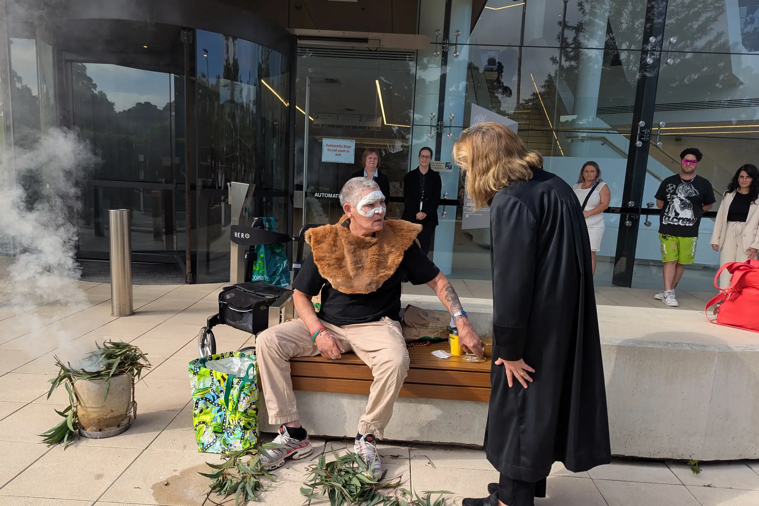 <p>Mark Merriman conducts a smoking ceremony before inquest findings on his brother\\'s death in custody. Photo: AAP/Miklos Bolza</p>\\n