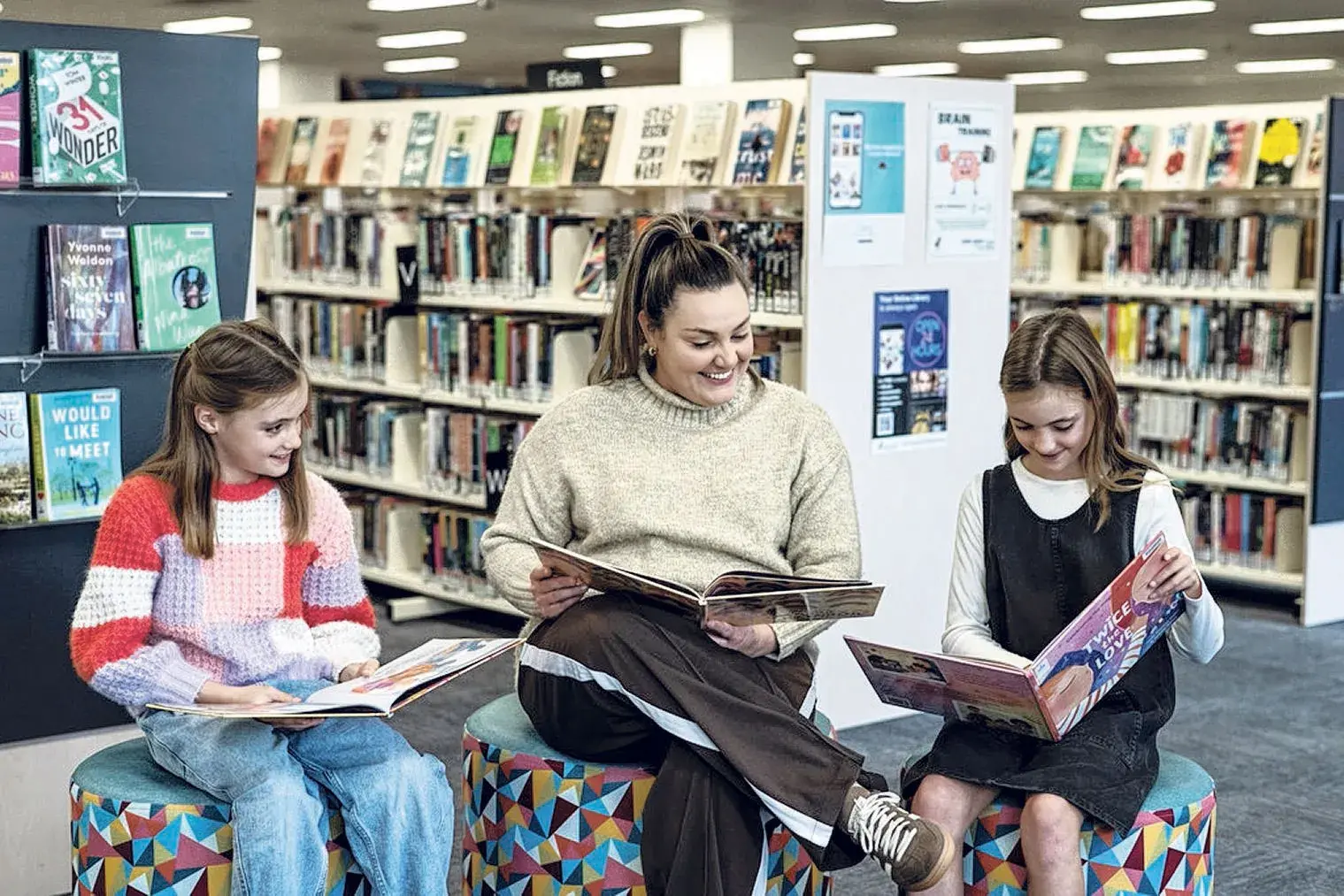 <p>Gabi Herbert with daughters Hallie (left) and Bridie (right) reading books at Dubbo Library,  July 29, 2025. Photos: Pip Farquarson, State Library</p>\\n