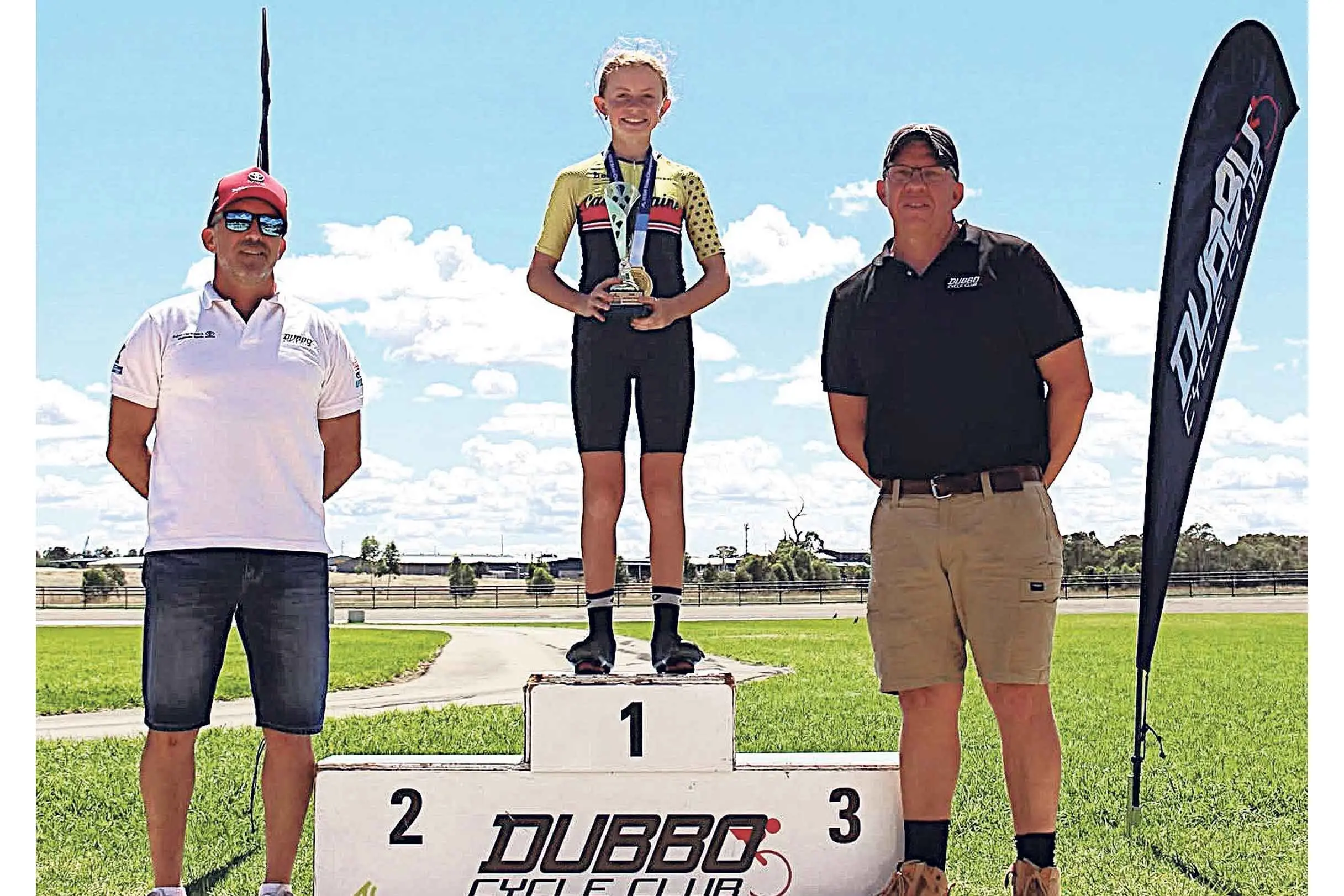 <p>Chloe Jackson, recipient of the Jackson Pascoe Memorial Trophy, with officials Jason Farr and Harry Pickering, at the 2026 AusCycling Junior State Championship at Dubbo. Photo: Dubbo Cycle Club</p>\\n