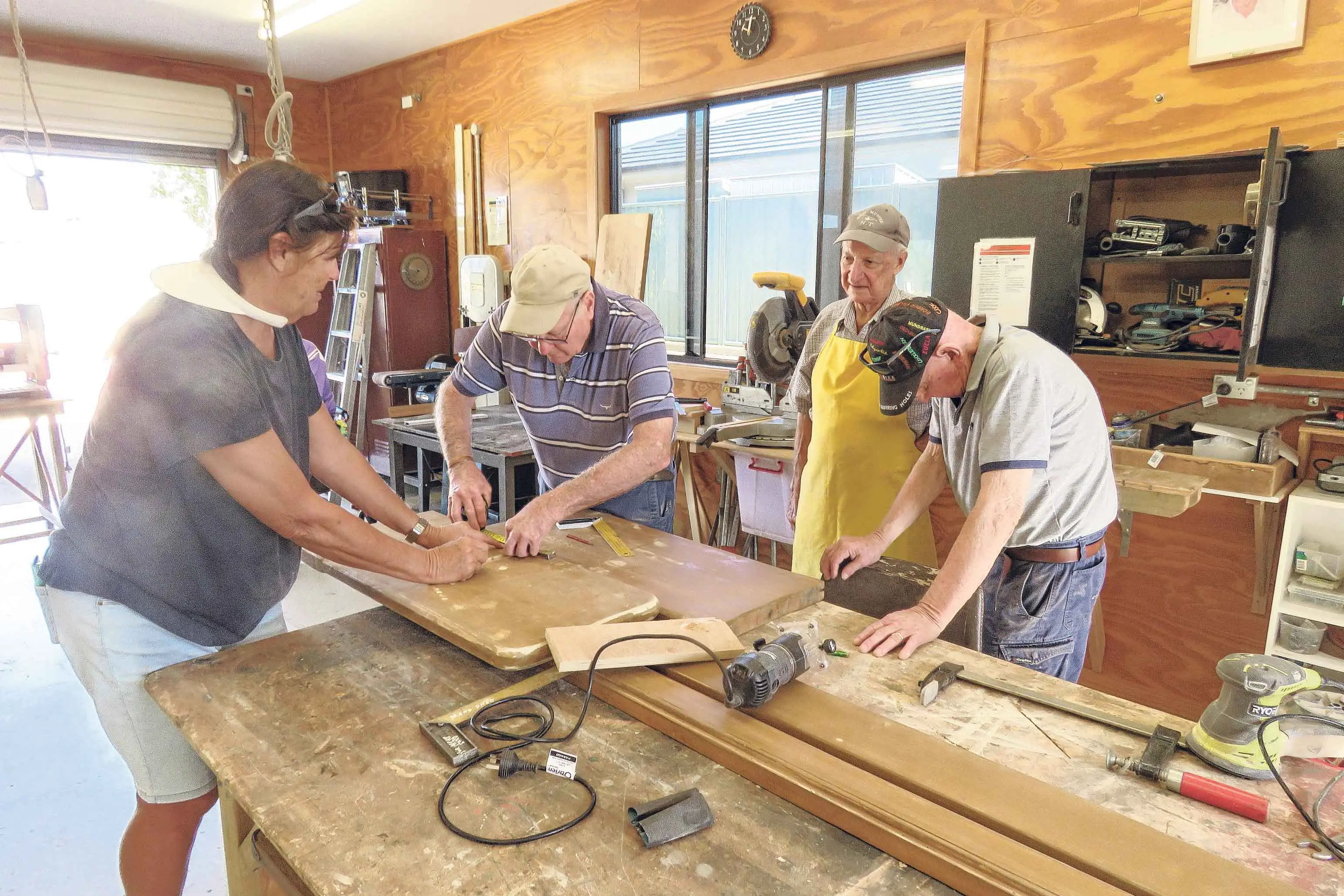 <p>Nita Morris, Ken Heckendorf, John Weldon and Col Ferguson working on a church pew at the open day. Photos: Alan Nelson</p>\\n
