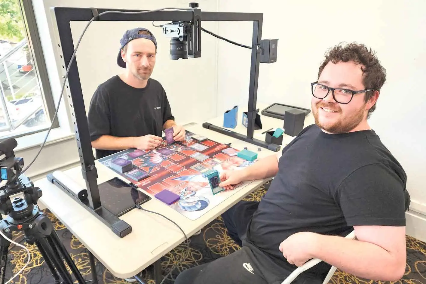 <p>Competitors Coady LoMonaco and Julius Martin at the live stream table during the Total Table Top Official Yu-Gi-Oh! World Championship Regional Qualifier at the Amaroo Hotel on Saturday, March 28. Photo: Dubbo Photo News/Ken Smith</p>\\n