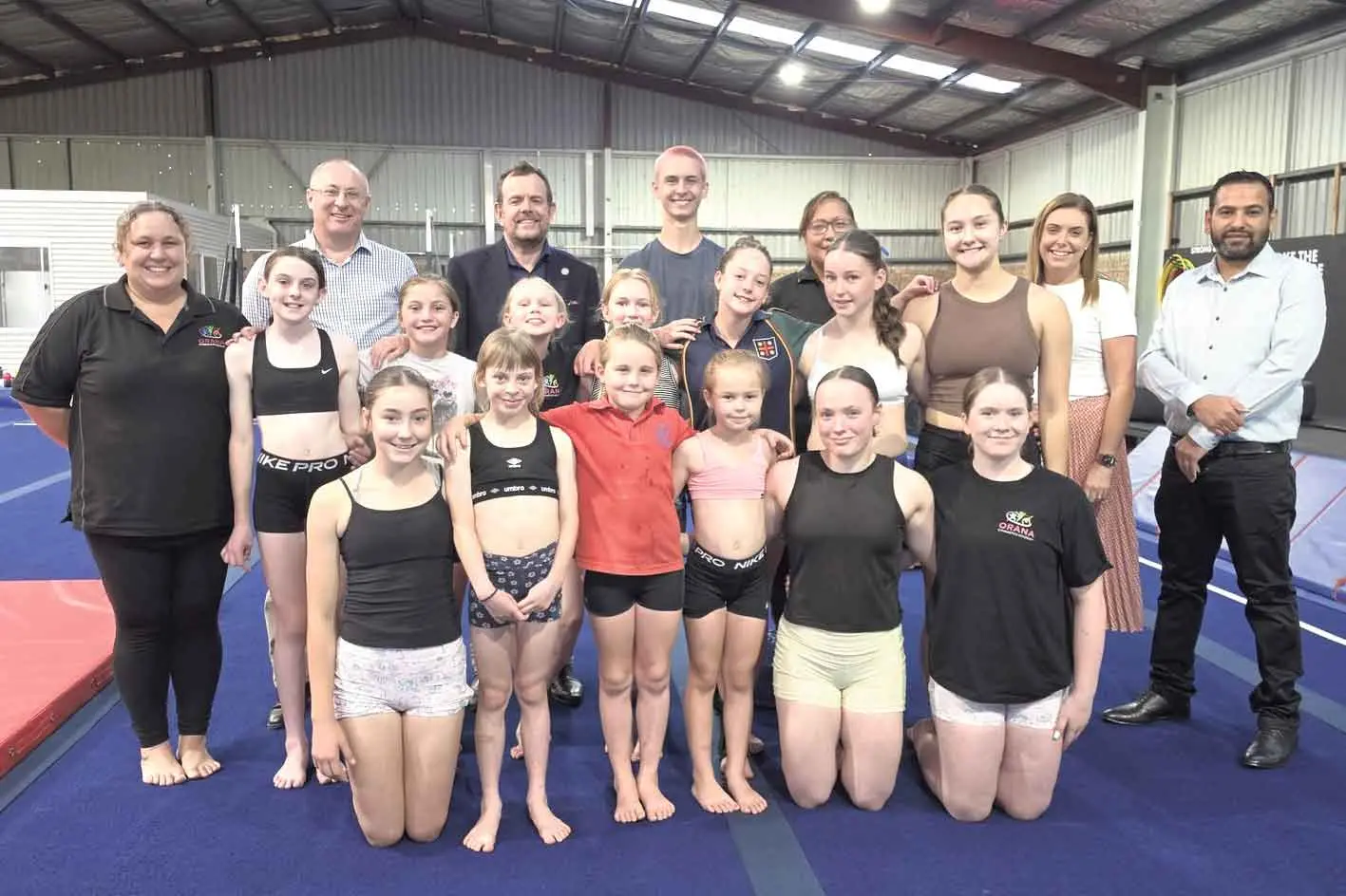 <p>Orana Gymnastics Academy students and staff are all smiles at the news their facility will receive a major grant. Photo: DNC/CCS</p>\\n
