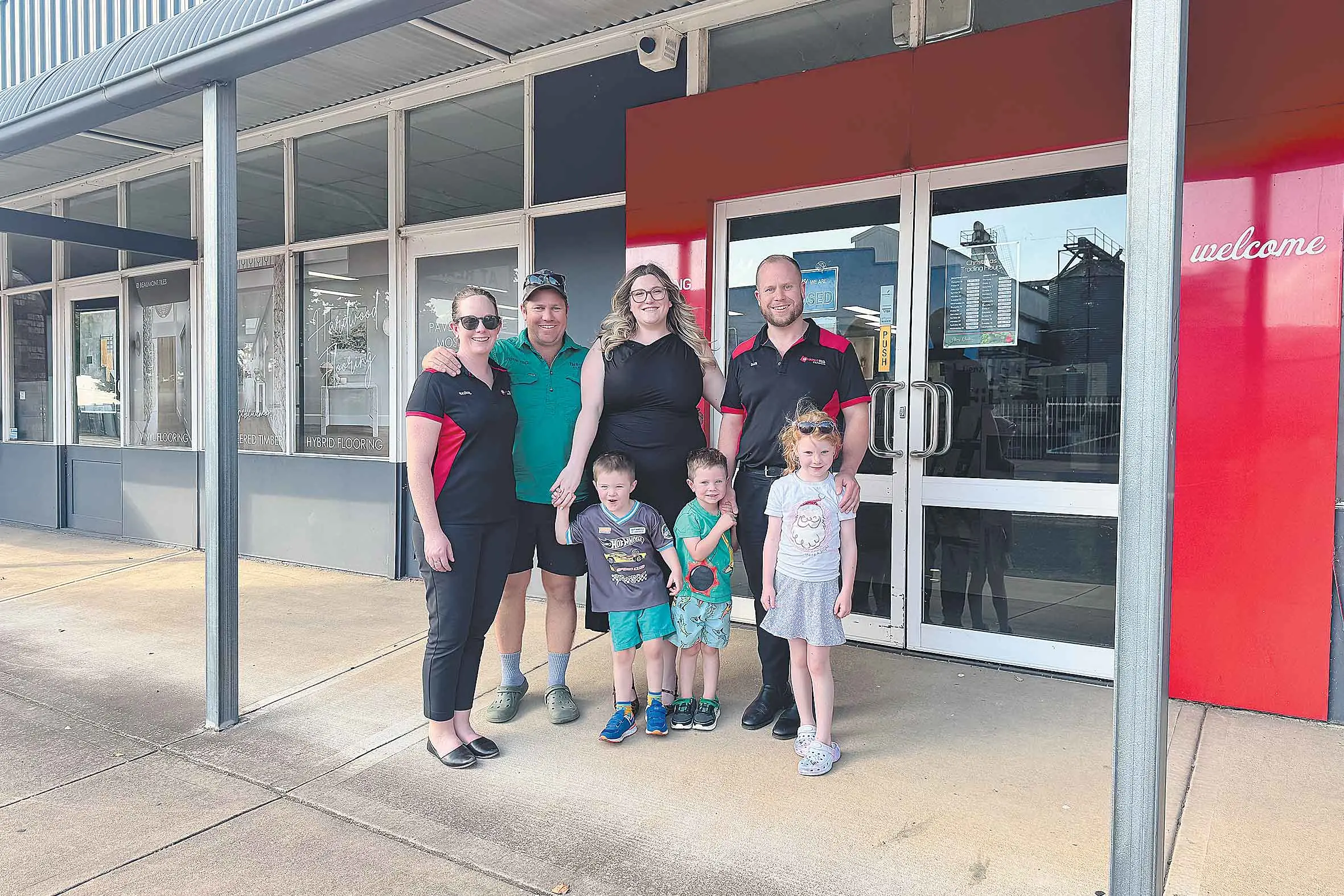 <p>All in the family: New local owners of Beaumont Tiles Dubbo, Dan and Sam Fisher alongside their families. Photos: Supplied.</p>\\n