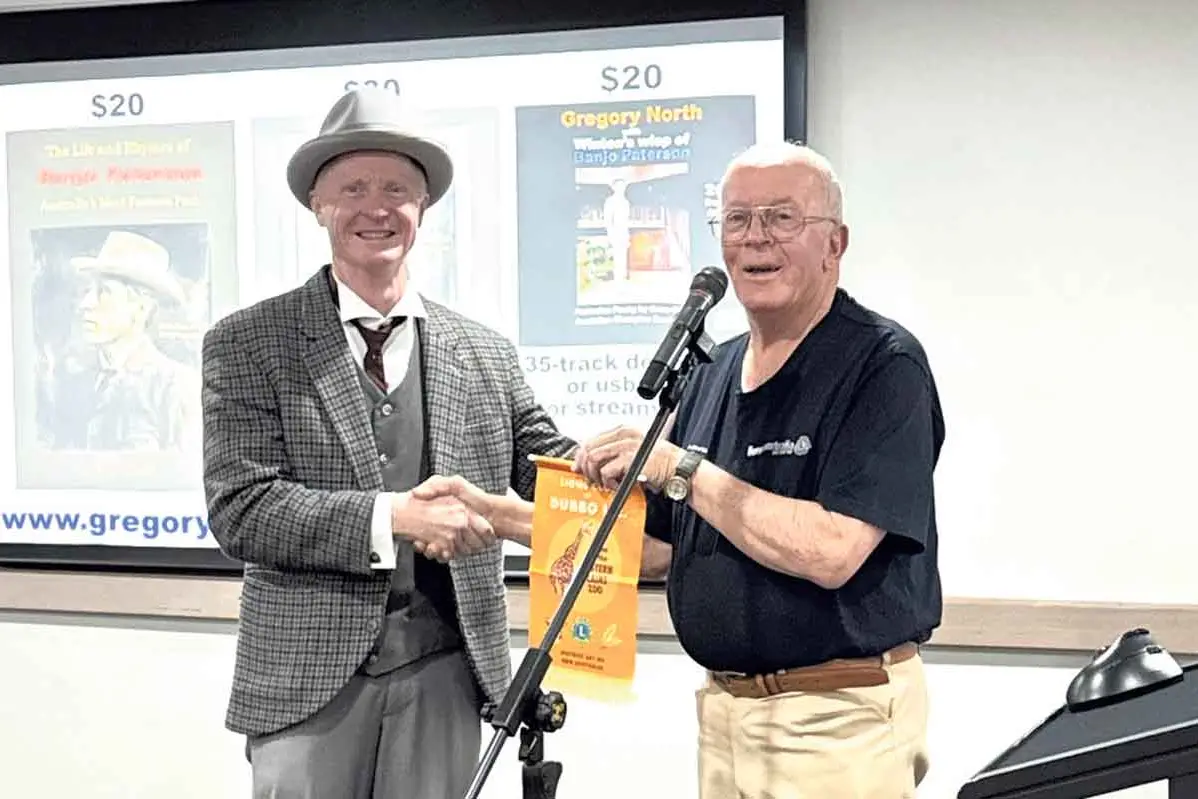 <p>Award-winning bush poet Greg North (left) with a Lions representative. Photo: Dubbo Lions</p>\\n