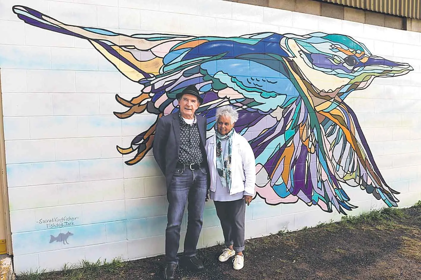 <p>Artist Jack \\'Fishdog\\' Randell in front of one of the public murals he created in Narromine, pictured with Aunty Ruth Carney. Photo: Dubbo Photo News/Sharon Bonthuys</p>\\n
