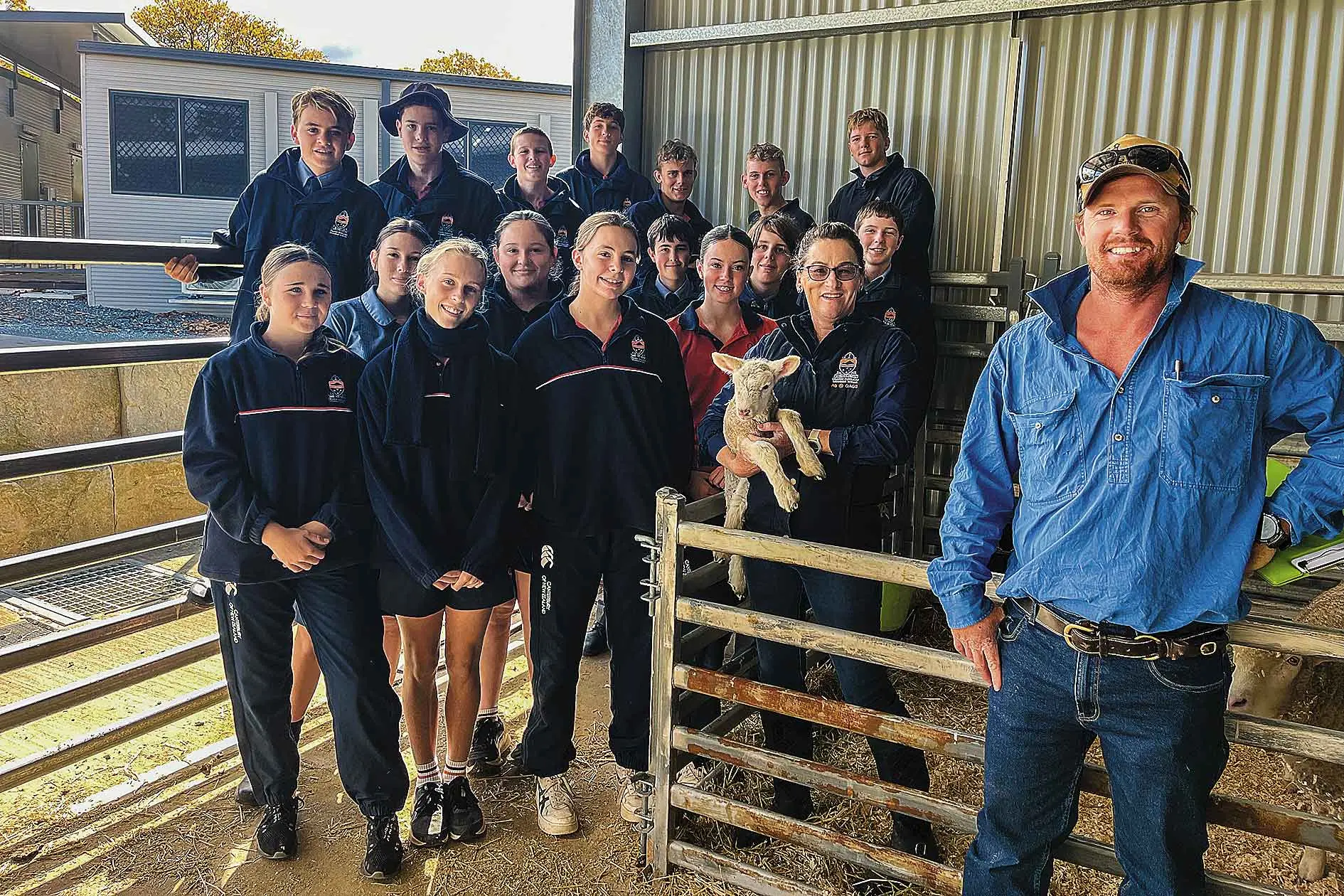 <p>Daniel Pumpa at Orange Anglican Grammar School with teacher Sarah Eyb and agricultural students. Photo: Supplied</p>\\n