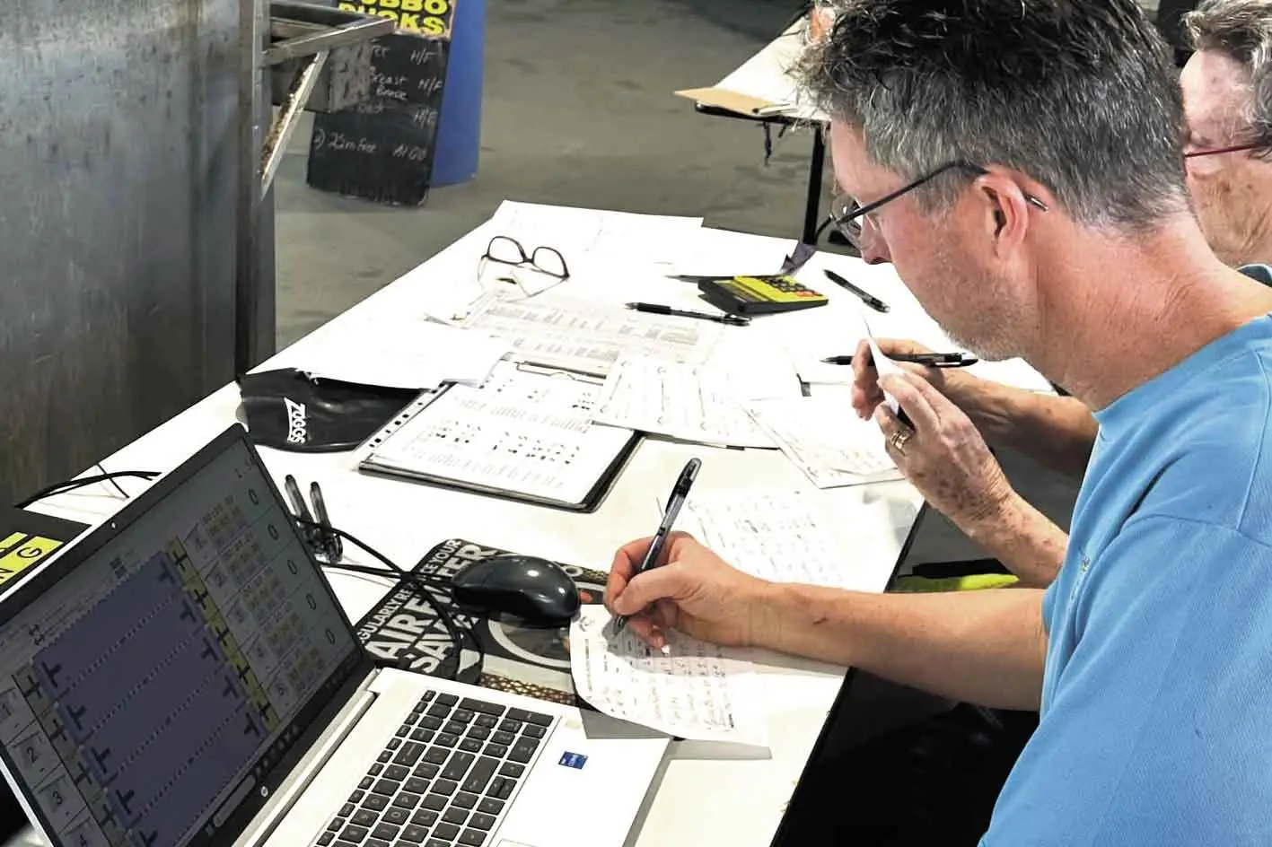<p>Mark Scullard on the computer keeping tabs for the Ducks latest meet. Photo: Supplied</p>\\n