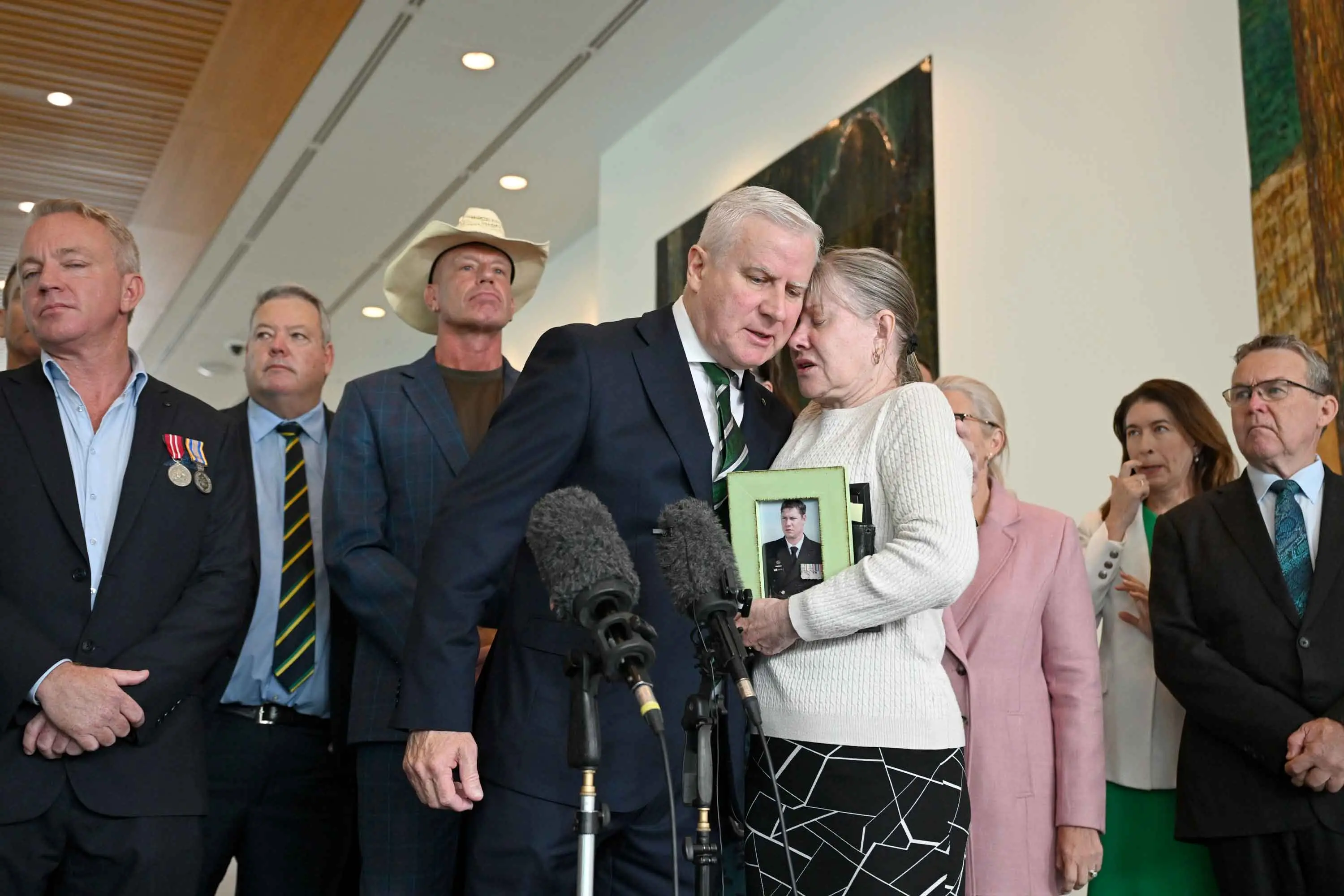 <p>Julie-Ann Finney, embracing Nationals MP Michael McCormack, fears more veterans will suffer. Photo: AAP/Lukas Coch</p>\\n