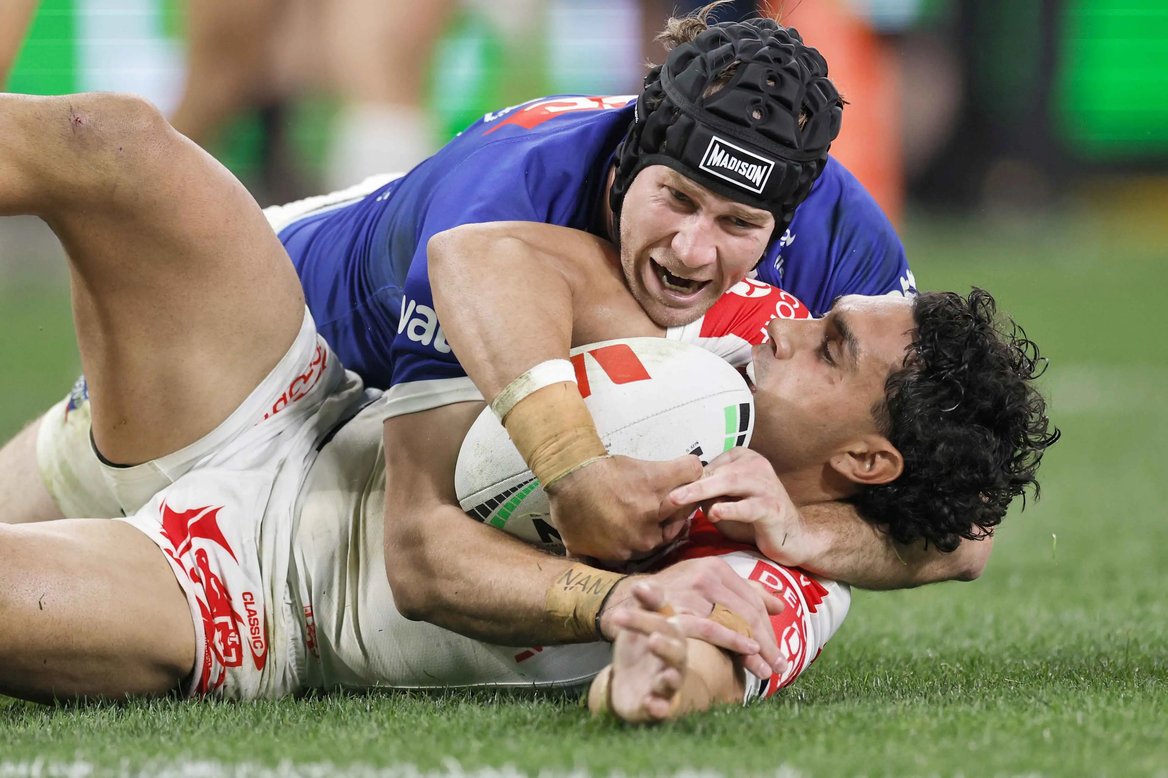 <p>Bulldogs\\' Matt Burton wraps up Dragons\\' Tyrell Sloan in a tackle during their match on Saturday. Photo: AAP/Mark Evans</p>\\n
