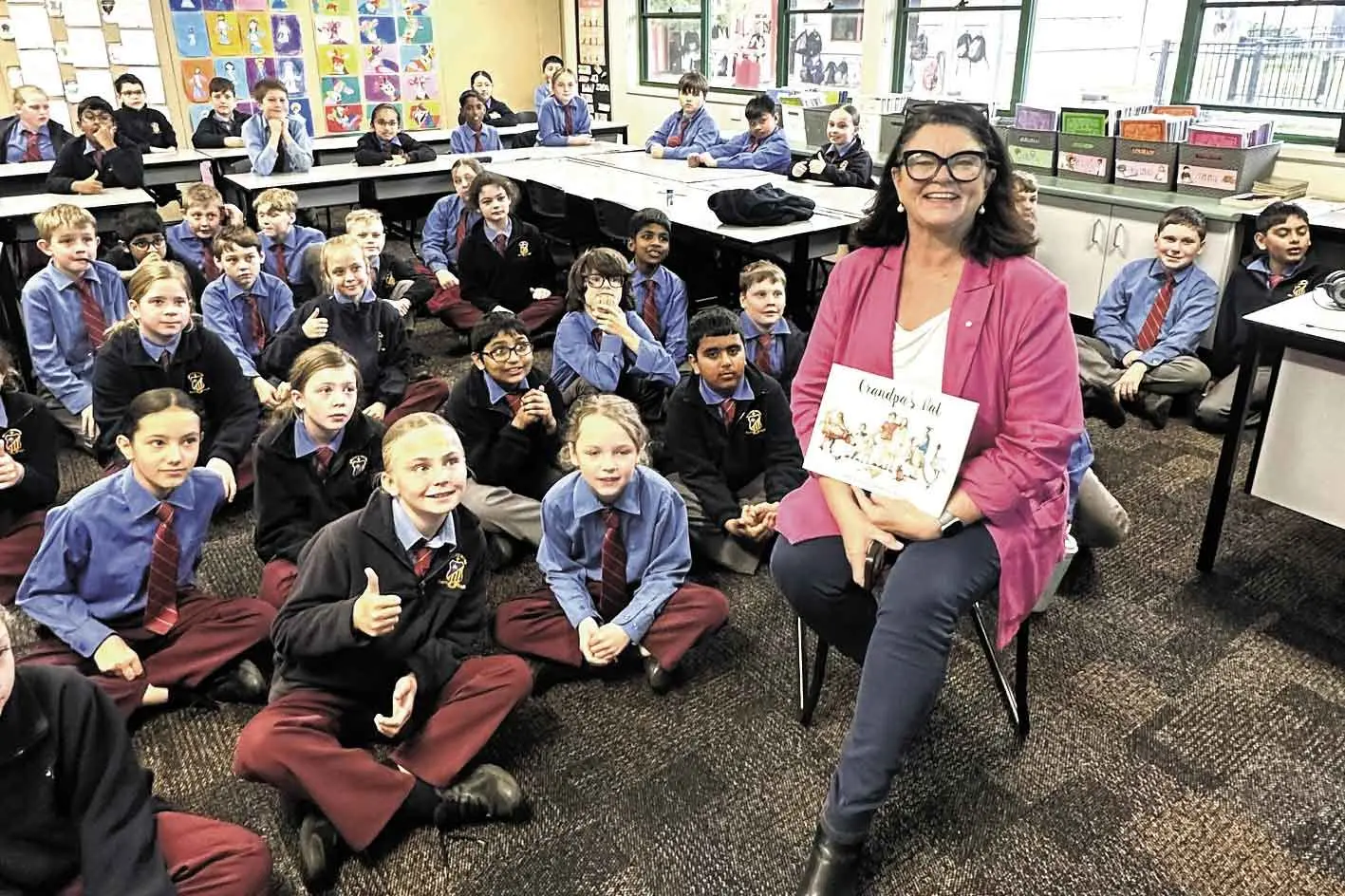 <p>Cr Jen Cowley, a respected author and journalist, shares her book \"Grandpa\\'s Hat\" during Book Week at St John\\'s. Photo: Dubbo Photo News</p>\\n