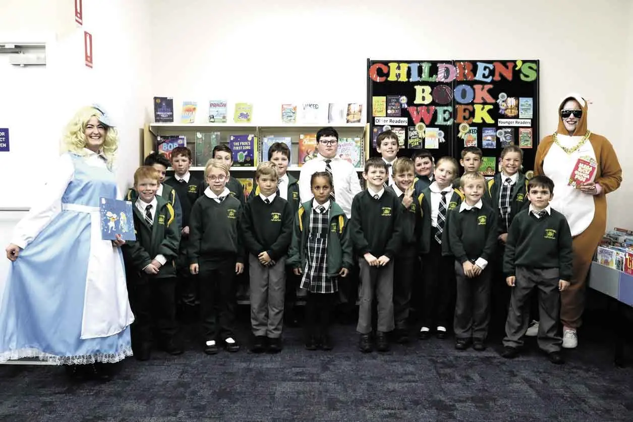 <p>St Augustine\\'s Parish School Stage 2 students with Alice in Wonderland and Mega Rich Guinea Pig at Book Week in the Narromine Shire. Photos: Macquarie Regional Library.</p>\\n