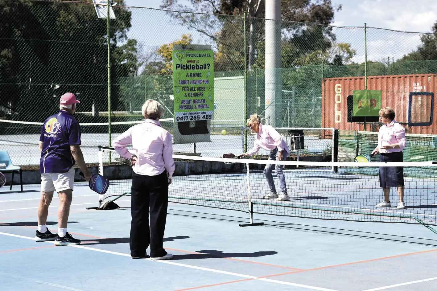 <p>Pink Angels take to the court with Greg King (left). Photo: Dubbo Photo News.</p>\\n